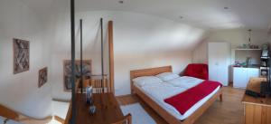 a bedroom with a bed and a table in it at Arthouse Apartment in Bad Vilbel