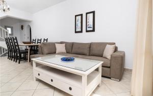 a living room with a couch and a table at Iliada Villas in Agios Prokopios