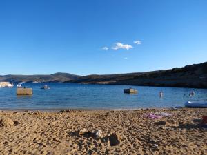a group of people in the water at a beach at Apartment Sv. Marak in Risika