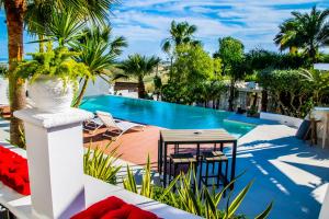 un patio con mesa y sillas y una piscina en Diodorus Luxury Experience en Favara