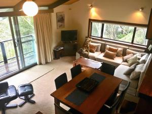 een woonkamer met een bank en een tafel bij Katmandu 1 in Falls Creek