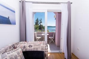 Postel nebo postele na pokoji v ubytování Apartmani Ferdi