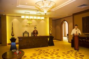 two men standing in the lobby of a hotel at Rongjiang Hotel in Jieyang