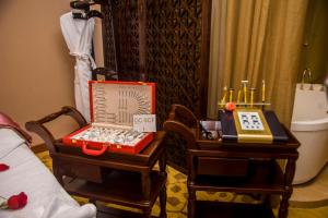 a room with two end tables with a suitcase on it at Rongjiang Hotel in Jieyang