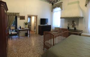 a bedroom with a bed and a living room at Hotel Sant'Antonin in Venice