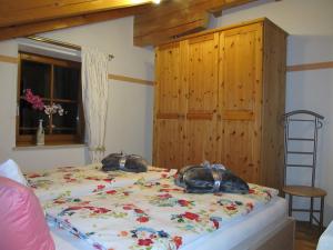 a bedroom with a bed with two bags on it at Ferienwohnung Bei Mutti in Rottau