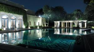a swimming pool in a house at night at Rambagh Palace in Jaipur
