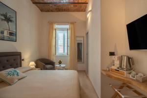 Ένα ή περισσότερα κρεβάτια σε δωμάτιο στο Corso Umberto Rooms
