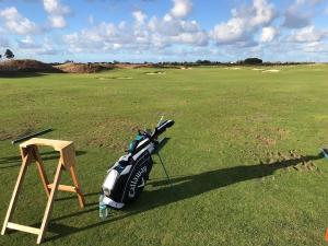 a golf club sitting on top of a green at Villa Alexis - Location de vacances à Trou aux Biches in Trou aux Biches