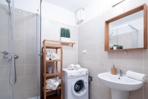 a bathroom with a washing machine and a sink at Vagabond Downtown in Budapest +144 photos
