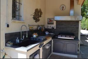 a kitchen with a sink and a stove at ChambreStudio bord de mer, Piscine et SPA in Six-Fours-les-Plages