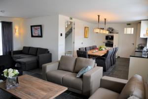 a living room with a couch and a table at Keyserbosch-Hof in Neer
