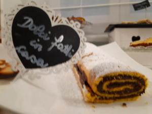 a piece of cake sitting on a plate with a heart at Bike&Boat Argentario Hotel in Porto Santo Stefano