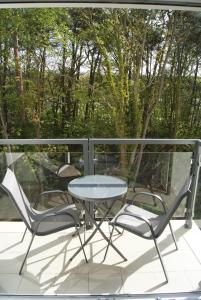 a table and two chairs on a balcony at Apartamenty Świnoujście - Wyspiańskiego 34e in Świnoujście