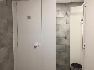 a white closet in a bathroom with a stone wall at Ingerichte De Waard tent - 5 personen in Beilen