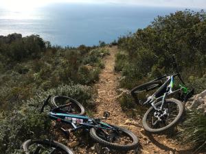two bikes parked on a trail near the ocean at Bike&Boat Argentario Hotel in Porto Santo Stefano