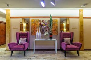 two purple chairs and a table in a room at Sweet Home Boutique Hotel in Tagbilaran City +44 photos