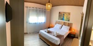 a bedroom with a bed and a window at Iliovasilema in Platy