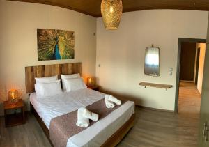 a bedroom with a bed with towels on it at Iliovasilema in Platy