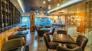a restaurant with tables and chairs in a room at Sweet Home Boutique Hotel in Tagbilaran City
