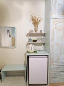 a kitchen with a counter with a tea kettle on it at Helena's Rooms in Kassiopi +42 photos