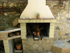 
a fire place with a brick wall and a brick oven at Emona Guest House in Nesebar
