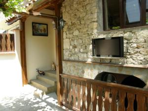 a stone wall with a flat screen tv on a wall at Emona Guest House in Nesebar