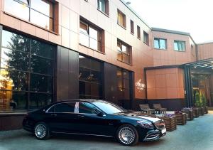 a black car parked in front of a building at Garden Hotel and Spa in Cheboksary