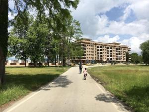 a man and a child walking down a path in a park at Between the lake and the forest in Ohrid