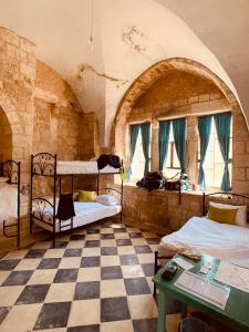 um quarto com 2 beliches e um piso em xadrez em Turquoise em Nablus