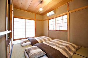 Cama ou camas em um quarto em Gunma House