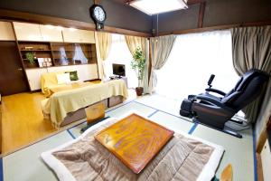 a view of a room with a bed and a desk at Gunma House in Maebashi