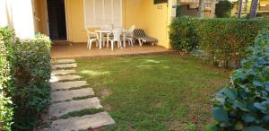 una casa con patio con mesa y sillas en Novo Sancti Petri Green del 11 en Chiclana de la Frontera