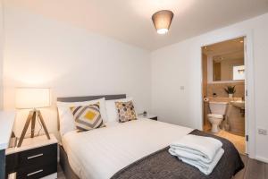 a bedroom with a bed with white sheets and pillows at Host & Stay - Oldham Place in Liverpool