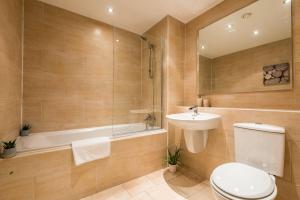 a bathroom with a toilet and a sink and a tub at Host & Stay - Oldham Place in Liverpool