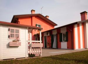 an orange and white house with a porch at Zio Stefy in Cittadella