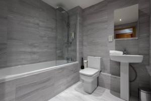a bathroom with a toilet and a sink and a bath tub at Host & Stay - Duke Street Living in Liverpool