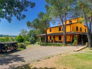 a large yellow house with a bench in front of it at Colours and scents from Tuscany await you in this wonderful property in Terranuova Bracciolini