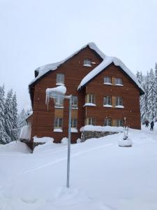 een groot bakstenen huis met sneeuw erop bij Apartmán Horní Mísečky J4 in Horni Misecky