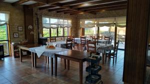 a kitchen and dining room with tables and chairs at Rústico Prado da Viña in Finisterre