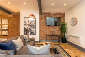 a living room with a brick wall at Host & Stay - Bands Warehouse I in Liverpool
