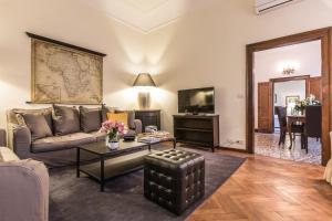 a living room with a couch and a table at Ca Dei Greci Canal View in Venice