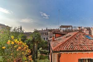 a view of a city with roofs and buildings at Ca Dei Greci Canal View in Venice