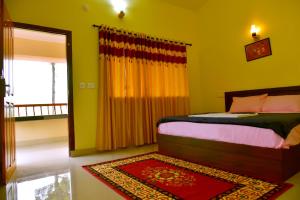 a bedroom with a bed and a window and a rug at Green Garden Deluxe Room in Vayittiri