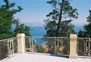 a balcony with a view of the water at Hotel Lovran in Lovran