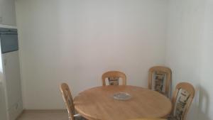 a dining room table with chairs and a table cloth at Tell Apartments Stans in Stans