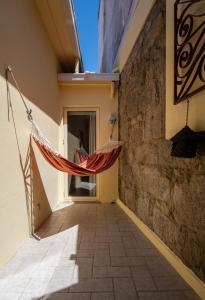 a hammock hanging from the side of a building at Porto Gaia City House by MP in Vila Nova de Gaia