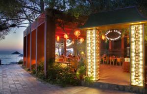 a restaurant with lights on a patio at night at Ephesia Holiday Beach Club in Kuşadası