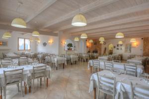 a dining room with white tables and chairs at La Locanda di Cucco in Finale Ligure