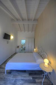 a bedroom with a large bed and a tv at La Locanda di Cucco in Finale Ligure